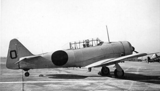 The original Beetle Bomb, a yellow North American SNJ with a “meatball” on the side and a zero on the tail. (Author unknown)